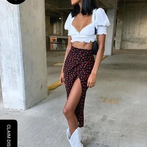 Long skirt from princess Polly with fed flowers on a black base skirt.